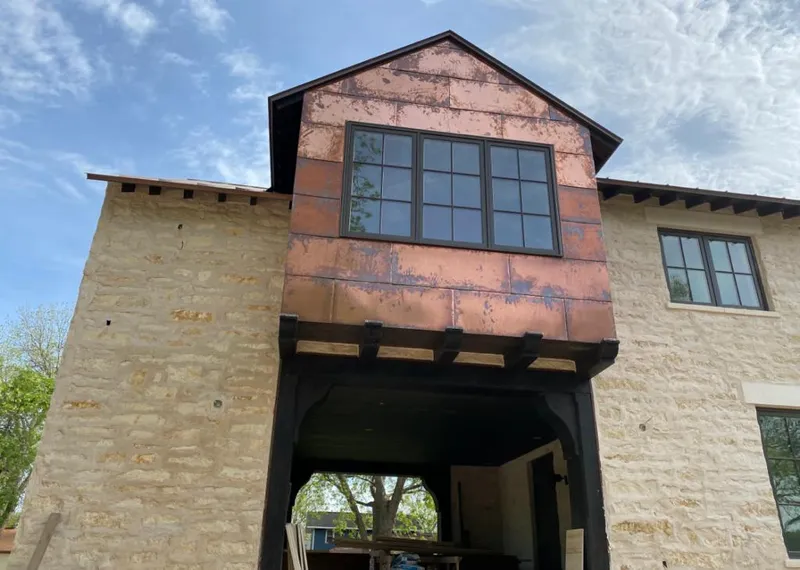 Copper metal panel facade on a stone building for Roof Repair in Rancho Palos Verdes